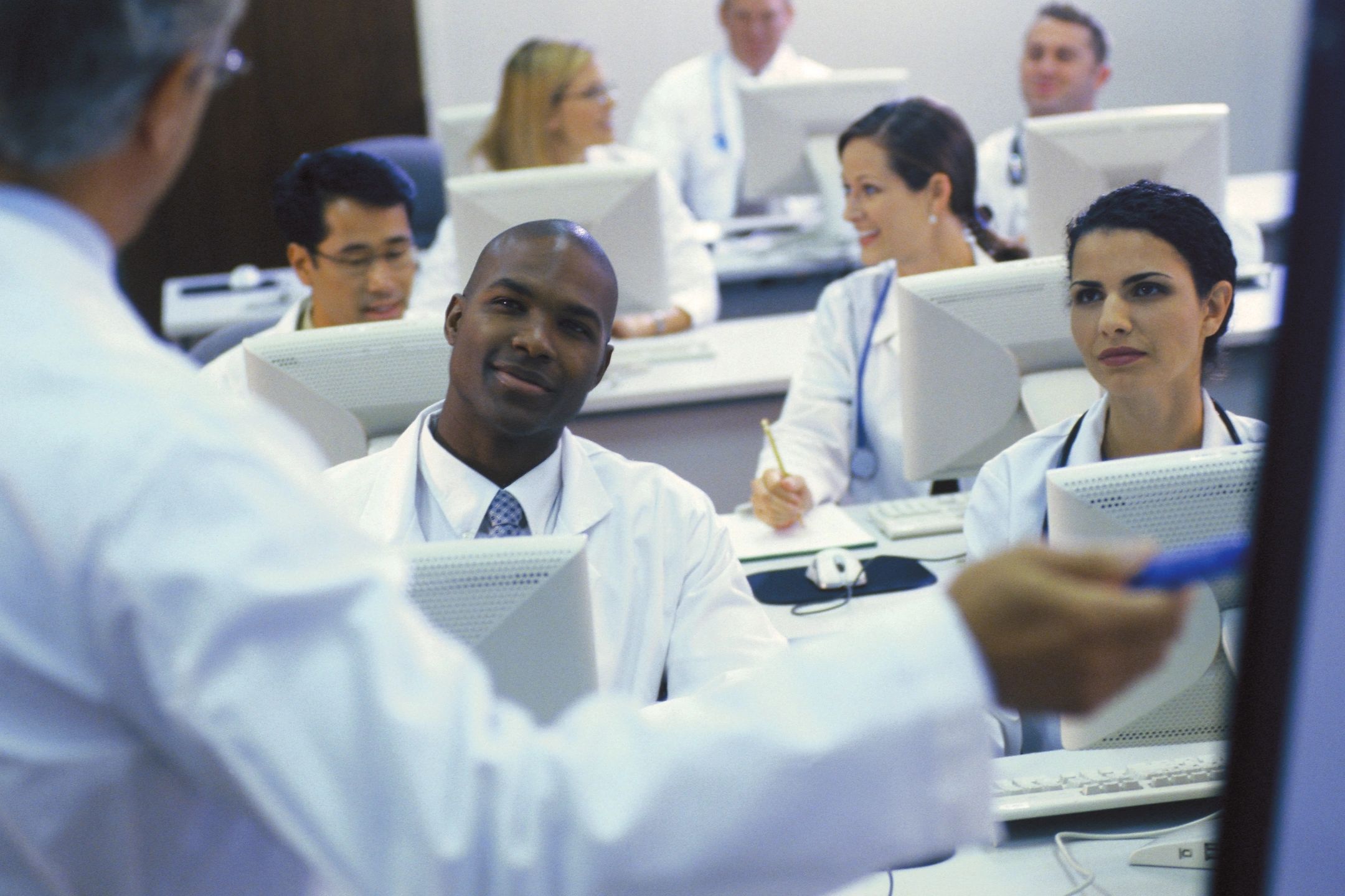 Doctors attending a presentation in a classroom.